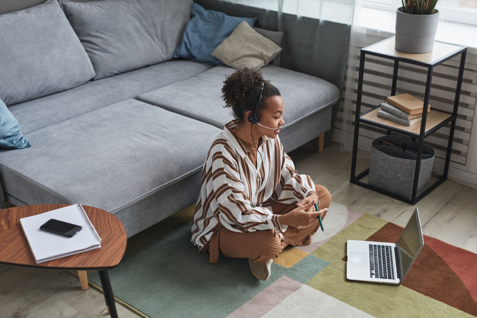 Member planning goals with a virtual trainer on a video call from home