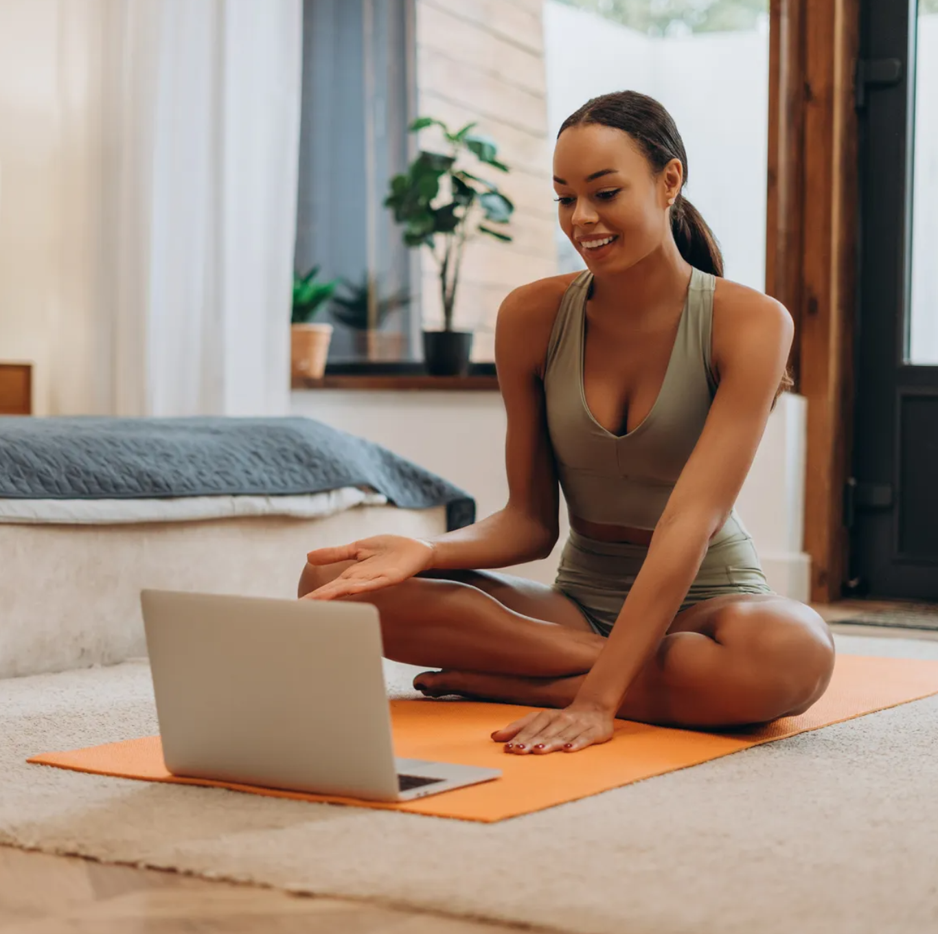 Member reviewing a workout on a laptop in a private training space